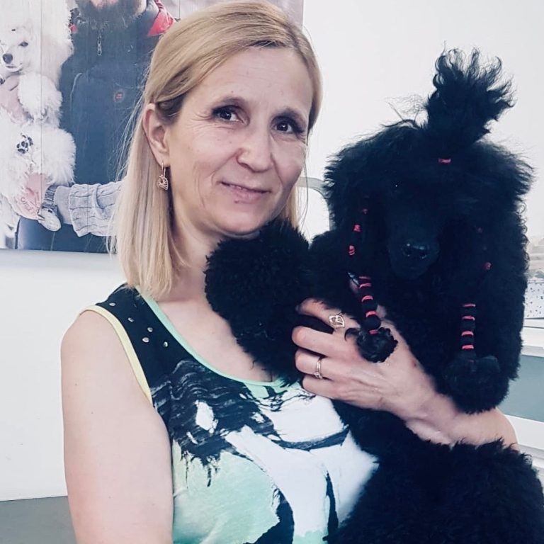 Groomer with a black dog